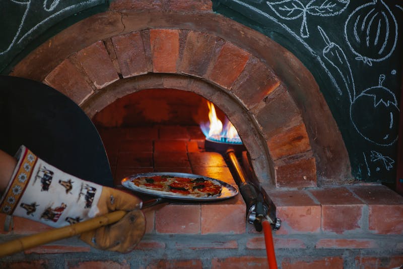 Fresh pizza coming out of the anthonys coal fired oven